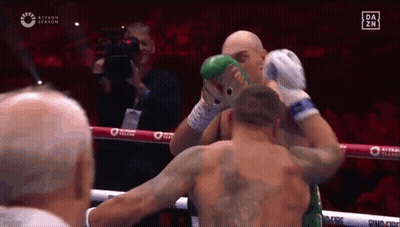 Two Men Are Fighting In A Boxing Ring And One Of Them Has A Tattoo On His Back . GIF
