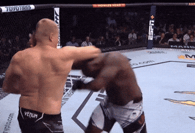 Two Men Are Fighting In A Boxing Ring And One Of Them Has Venum On His Shorts GIF