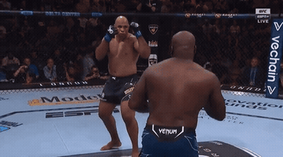 Two Men Are Fighting In A Boxing Ring And One Of Them Has Venum On His Shorts GIF