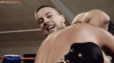 Two Men Are Fighting In A Boxing Ring And One Of Them Is Smiling GIF