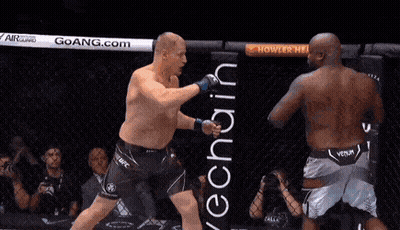 Two Men Are Fighting In A Boxing Ring And One Of Them Is Wearing A Venum Shorts GIF
