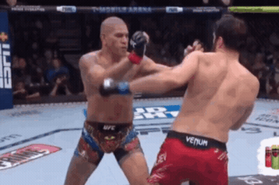 Two Men Are Fighting In A Boxing Ring And One Of Them Is Wearing A Venum Shorts GIF