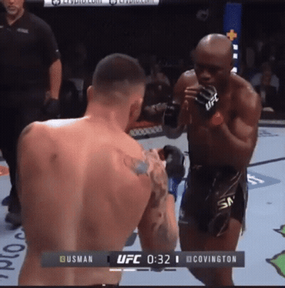 Two Men Are Fighting In A Boxing Ring And The Ufc Fight Is Underway GIF