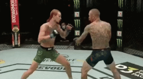 Two Men Are Fighting In A Boxing Ring With A Banner For Bodyarmor In The Background GIF