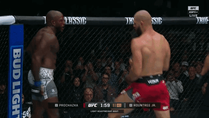 Two Men Are Fighting In A Boxing Ring With A Bud Light Banner In The Background GIF