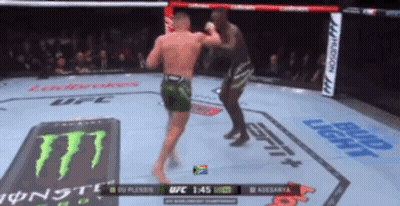 Two Men Are Fighting In A Boxing Ring With A Monster Energy Logo On The Floor GIF