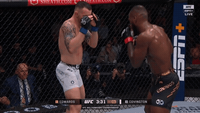 Two Men Are Fighting In A Boxing Ring With A Sign That Says Espn + GIF