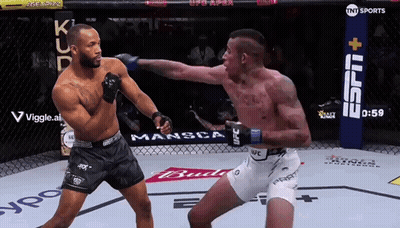 Two Men Are Fighting In A Boxing Ring With A Tnt Sports Sign In The Background GIF