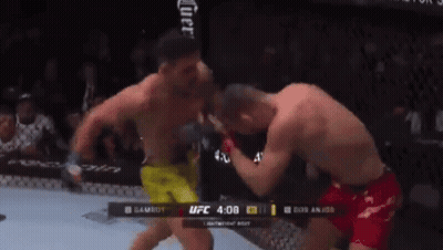 Two Men Are Fighting In A Boxing Ring With The Ufc Logo In The Corner GIF