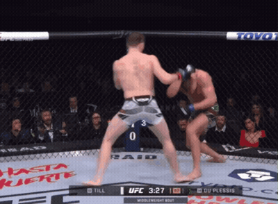 Two Men Are Fighting In A Boxing Ring With The Ufc Logo On The Corner GIF