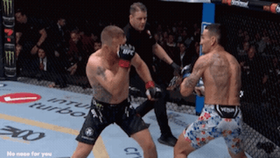 Two Men Are Fighting In A Boxing Ring With The Word Turbo On The Wall GIF