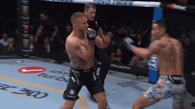Two Men Are Fighting In A Boxing Ring With Toyo Tires On The Side GIF