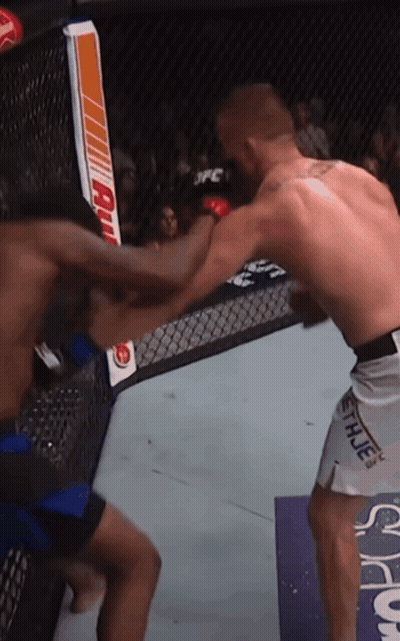 Two Men Are Fighting In A Cage And One Of Them Is Wearing Shorts With The Word Hue On Them GIF