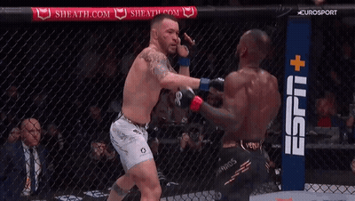 Two Men Are Fighting In A Cage With A Espn + Sign In The Background GIF