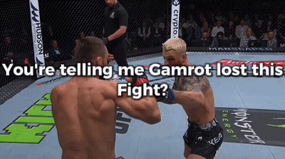 Two Men Are Fighting In A Cage With The Words " You 'Re Telling Me Gamrot Lost This Fight " Below Them GIF