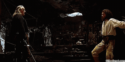 Two Men Are Fighting In A Dark Room With Gifsplanet.com At The Bottom Of The Image GIF