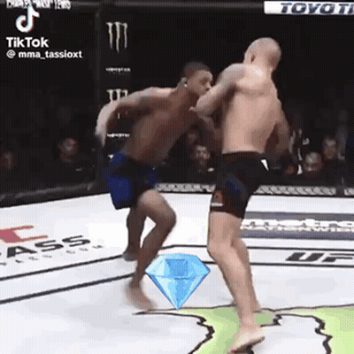 Two Men Are Fighting In A Ring With A Diamond In The Middle . GIF