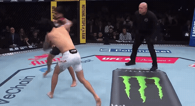 Two Men Are Fighting In A Ring With A Monster Energy Drink On The Ground GIF