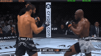 Two Men Are Fighting In A Ring With A Sign That Says Crypt.com On It GIF