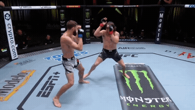 Two Men Are Fighting In A Ring With Monster Energy Advertisements GIF