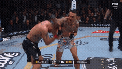 Two Men Are Fighting In A Ufc Ring And The Clock Shows 3:07 GIF