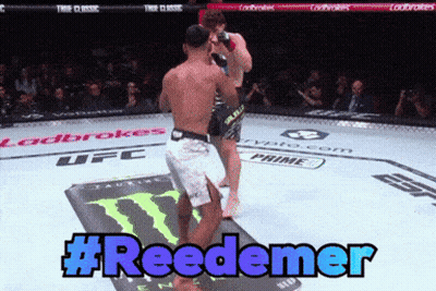 Two Men Are Fighting In A Ufc Ring And The Hashtag #Reedemer Is Displayed GIF
