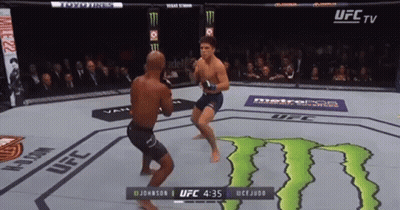 Two Men Are Fighting In A Ufc Ring With A Monster Energy Logo In The Background GIF