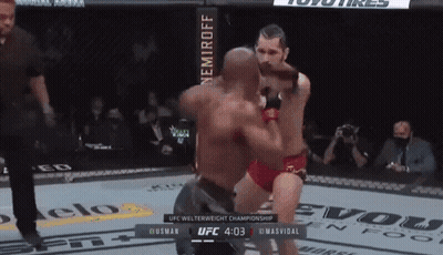 Two Men Are Fighting In A Ufc Welterweight Championship Match Between Husman And Masvidal GIF