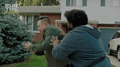 Two Men Are Fighting In Front Of A House With The Words Run The Burbs On The Bottom GIF