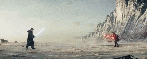 Two Men Are Fighting With Lightsabers In A Snowy Field GIF