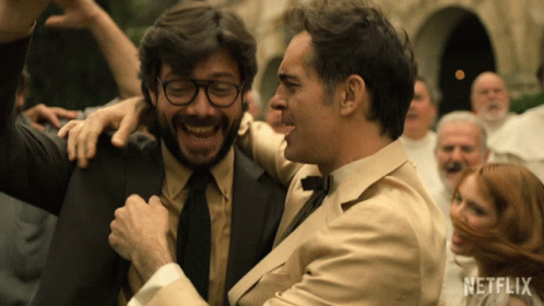 Two Men Are Hugging And Laughing In Front Of A Crowd With A Netflix Logo In The Corner GIF