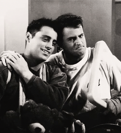 Two Men Are Hugging Each Other And One Has The Number 1 On His Shirt GIF