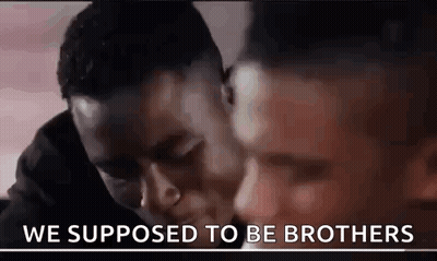 Two Men Are Hugging Each Other And The Words `` We Supposed To Be Brothers '' Are Written On The Bottom Of The Image . GIF