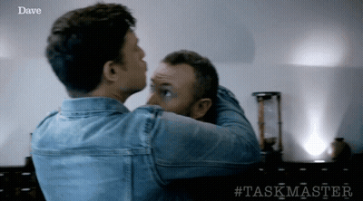 Two Men Are Hugging Each Other With The Word Dave On The Bottom Right GIF