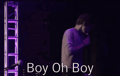 Two Men Are Hugging In Front Of A Microphone And The Words Boy Oh Boy Are Visible GIF