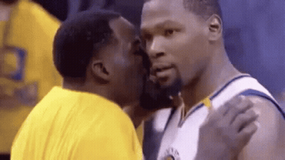 Two Men Are Kissing Each Other On The Cheek . GIF