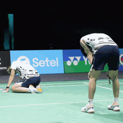Two Men Are Kneeling On A Tennis Court In Front Of A Setel Ad GIF