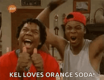Two Men Are Laughing And Giving A Thumbs Up While Standing Next To Each Other In A Living Room . GIF