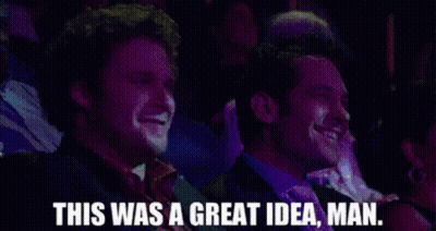 Two Men Are Laughing In A Crowd And One Of Them Is Saying This Was A Great Idea Man . GIF