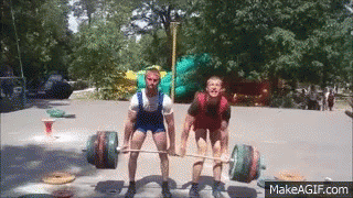 Two Men Are Lifting A Barbell In A Park With Makeagif.com At The Bottom GIF