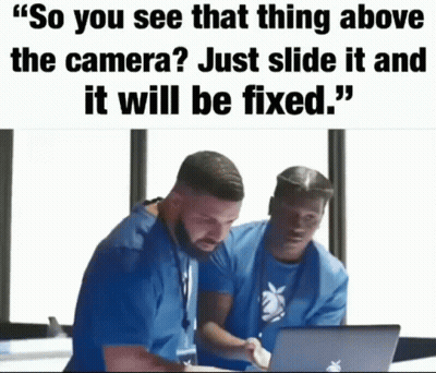 Two Men Are Looking At A Laptop And One Of Them Says " So You See That Thing Above The Camera Just Slide It And It Will  GIF