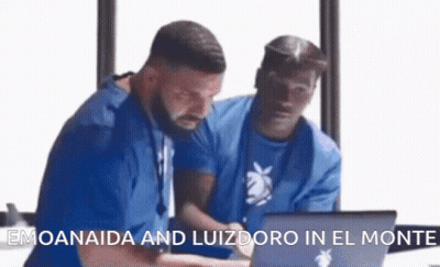 Two Men Are Looking At A Laptop With The Words Emoanaida And Luizdoro In El Monte On The Bottom . GIF