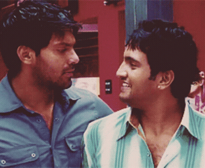 Two Men Are Looking At Each Other And One Of Them Is Wearing A Green Shirt GIF
