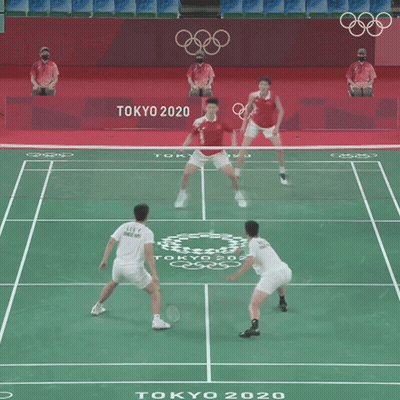 Two Men Are Playing A Game Of Badminton In Tokyo 2020 GIF
