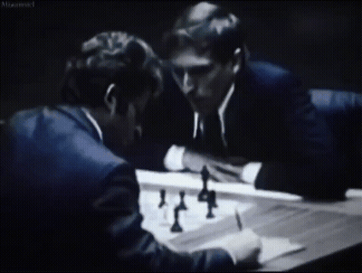 Two Men Are Playing A Game Of Chess In A Black And White Photo With A Caption That Says " Misconnected " GIF