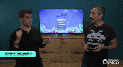 Two Men Are Playing A Video Game With Jimmy Tallarico Standing Behind Them GIF