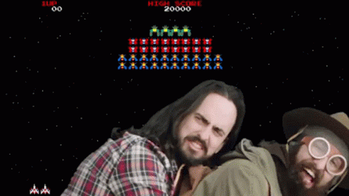 Two Men Are Playing A Video Game With The High Score Of 20000 GIF
