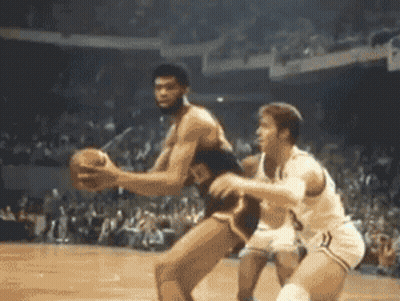 Two Men Are Playing Basketball In Front Of A Crowd And One Has The Number 3 On His Shorts GIF