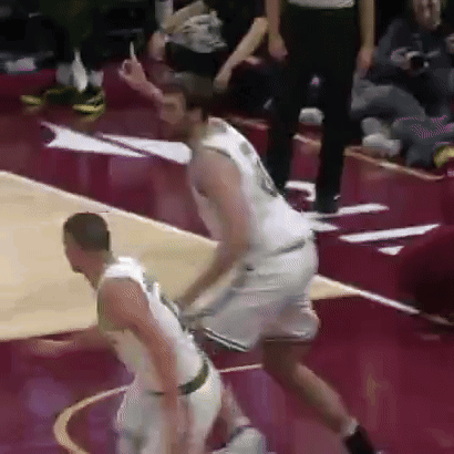 Two Men Are Playing Basketball On A Court And One Of Them Is Wearing A White Jersey With The Number 18 On It . GIF