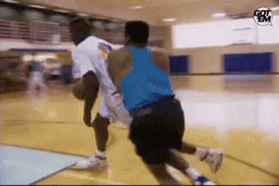 Two Men Are Playing Basketball On A Court With A Got Em Logo In The Corner GIF